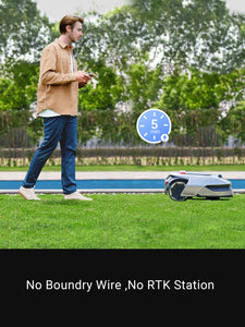 Man using Dreame Roboticmower A1 on lawn, showcasing wireless boundary setup features.